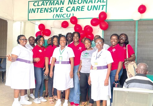 Some members of the Absa Bank August borns (in red) with heads of the hospital at the general ward