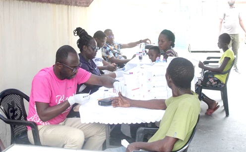  A member of  the medical team attending to a beneficiary