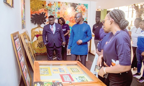  Bice Osei Kuffuor (left), Managing Director, Ghana Post, with Nana Kofi Asafu-Aidoo (middle), Executive Director, Ghana Domain Name Registry, Ministry of Communications, inspecting philatelic stamps of Ghana Post