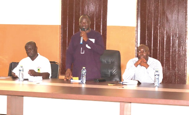 Mathias Gangana (standing) addressing the participants. With him includes James Awapoayi (right), Jasikan Municipal Coordinating Director