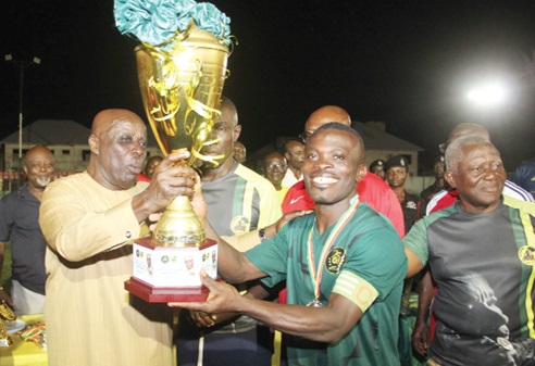 Osagyefuo Amoatia Ofori Panin (left), the Okyenhene, presenting the cup to Okyere Ahenkorah, the captain of the Kyebi team. Picture: NANA KONADU AGYEMAN