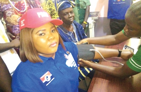  Jennifer Dede Adjabeng, MCE for La Nkwantanang-Madina, being assisted by a nurse to check her blood pressure