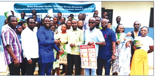  Enoch Owusu (3rd from right), Dormaa West District Director, GES, receiving rabies prevention education materials from Ernest Amoah-Ampah (3rd from left), National SHEP Unit