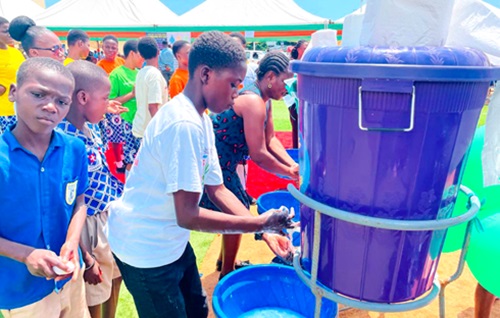 Children demonstrating how to properly wash hands