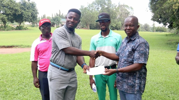 Lucky Ayisah (L) receiving the winner's cheque from Prof Benard Kofi Baiden ( R)
