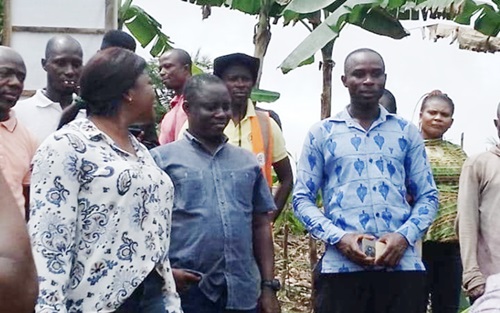 Ophelia Mensah Hayford (left), Minister of Environment, Science, Techonology and Innovation, interacting with some farmers at Twifo Abuoso