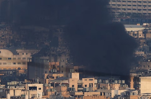Smoke billows over Beirut's southern suburbs after an Israeli strike, amid the ongoing hostilities between Hezbollah and Israeli forces, as seen from Hadath