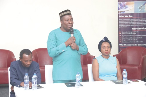 Dr Stephen Ayisi (standing), President, Ghana Palliative Care Association, addressing the ceremony. With him are Dr Bisi Adewale (right), Chairperson of the Research Committee, and Rev. Alex Ohemeng, Member of the Executive Council. Picture: ELVIS NII NOI DOWUONA