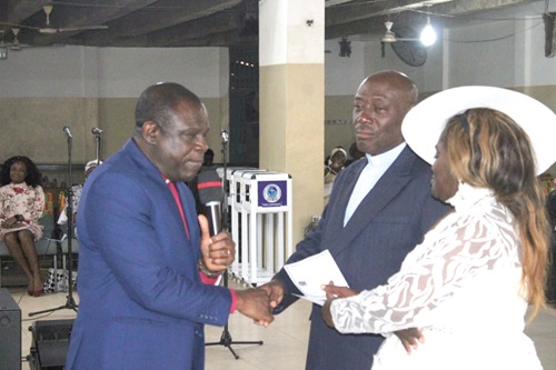  Rt. Rev. Prosper Samuel Dzomeku (left), the Moderator, GEC, congratulates Rev. Dr Kormi Hiagbe, the retiree, and his wife, Yaa Aseda Adom Hiagbe