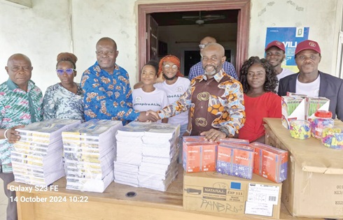 Michael Odartey-Wellington (3rd from right), Managing Director of Panbros Salt Industries Ltd, handing over the school supplies to Henry Ayetse (3rd from left), Ga South Municipal Director of Education 