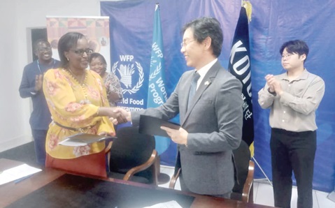 Dong Hyun Lee (right), Country Director, KOICA, exchanging documents with Aurore Rusiga, Country Director, WFP Ghana, after signing the memorandum of understanding