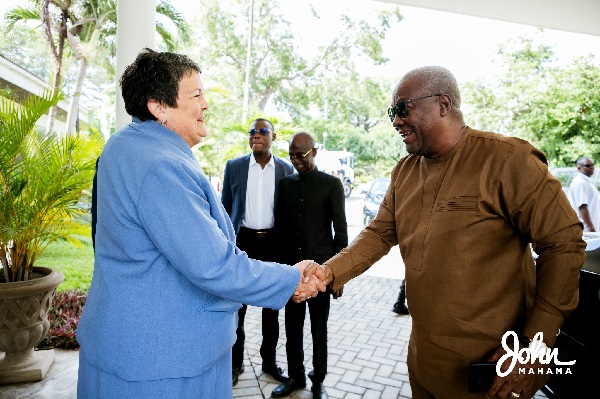 John Dramani Mahama, presidential candidate of Ghana's opposition National Democratic Congress (NDC) in a handshake with the U.S. Ambassador Virginia Palmer 