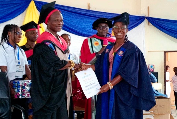 Dr David Tenkorang-Twum (left) presenting the overall best graduating student to Millicent Darkwah