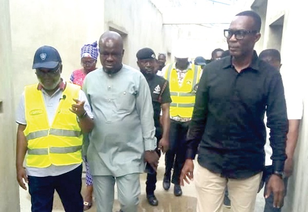  Dr Anthony Nsiah-Asare (left), the Government Advisor on Health; Ambrose Edward Tsegah (right), the MCE for the Ga Central Municipality, inspecting the project