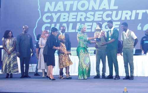 Samira Bawumiah (4th from right), wife of the Vice-President, presenting the trophy to St. Peters SHS. With them are other dignitaries. Picture: ERNEST KODZI