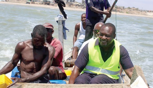Prof. David Dodoo-Arhin (seated right), Director of IAST, on an outboard motor-powered canoe 