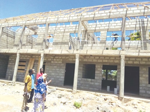 Some of the committee members being conducted round the project