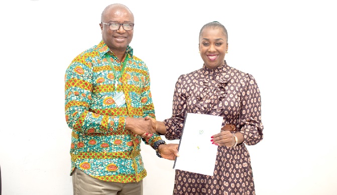 Prof. Eric Nyarko-Sampson (left), Vice Chancellor of the University of Environment and Sustainable Development, exchanging the signed MoU with Dr Abena Asomaning, MD of AfESC