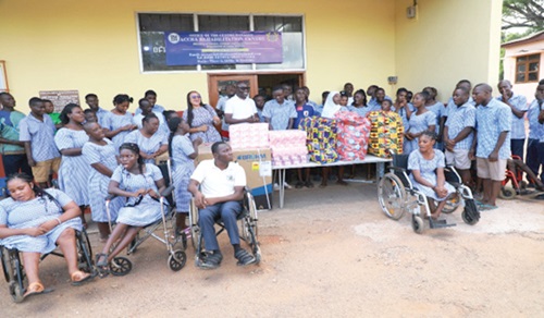  Kofi Yeboah (arrowed) presenting the items to William Ohene, Deputy Centre Manager, while Seth Dzidzornu, the Centre Manager of the ARC, and trainees of the centre look on