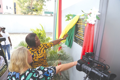 Ophelia Hayford Mensah (right), the Minister of Environment, Science, Technology and Innovation, being assisted by Franziska Jebens (left), the Head of Cooperation, German Embassy, to inaugurate the E-Waste plant (right) in Accra. Picture: SAMUEL TEI ADANO