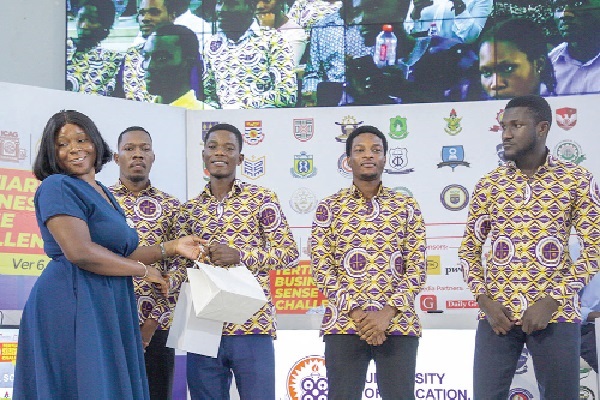 Dericka Patamia, Marketing assistant of Compu-Ghana, presenting an award the second runner up team members