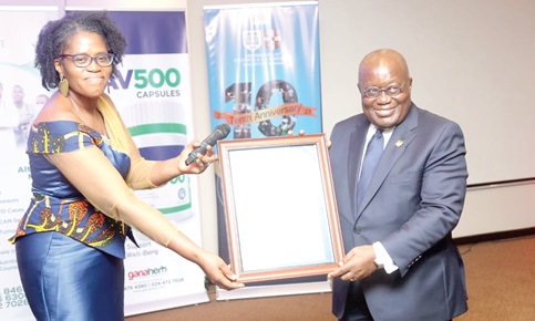 President Akufo-Addo (right), receiving a citation from Dr Emefa Takyi Amoako, Co-Chairman of OXCAM. Picture: SAMUEL TEI ADANO