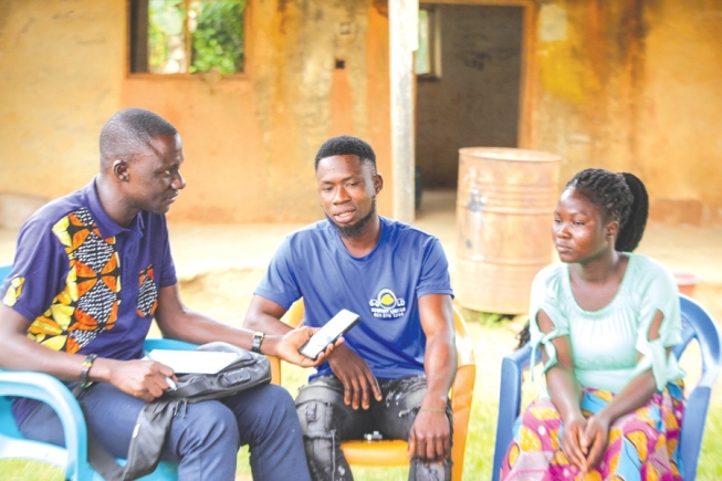 Evans Dogbe (middle) and Kate Agboga (right), parents of the twins who drowned in a galamsey pit, speaking to Graphic Online's Timothy Ngnenbe.