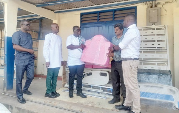 Louis Azasoo (2nd from right), the Sales Manager of Advent International Limited, presenting the hospital beds to Dr Frank Owusu-Sekyere (3rd from left), Director, Medical Affairs, KBTH. Looking on are Anand Machindra Dalvi (right), Service Manager, Advent International Limited, and Mustapha Salifu (2nd from left), Head, Public Relations, KBTH