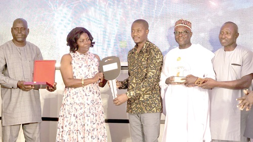 Lydia Seyram Alhassan (2nd from left), Minister of Sanitation and Water Resources, presenting the Overall Best Award to Mohammed Yakubu Ahmed, the Chief Executive of the Sagnarigu Municipal Assembly