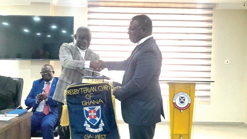 Rev. Dr Joseph Kofi Antwi (left), immediate past Clerk  of the Ga West Presbytery of the Presbyterian Church of Ghana, handing over to his successor, Rev. Kennedy Asante Sarpong 