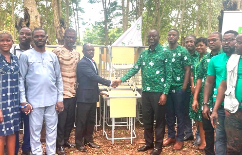 Samuel Yeboah (7th from right), Chief Operating Officer of GIRSAL, presenting the furniture to Ernest Abiew (5th from left), Principal of Ohawu Agricultural College