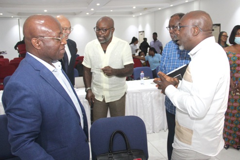 Osei Kyei-Mensah-Bonsu (left), the Minister of Parliamentary Affairs, interacting with some of the participants in the event. They are Kofi Bentil (right), Vice President of Imani Ghana, Frank Adu Jr (middle), a former Managing Director of Cal Bank, and Dr D. K. Amoako (2nd from right), President of the African Centre for Transformation