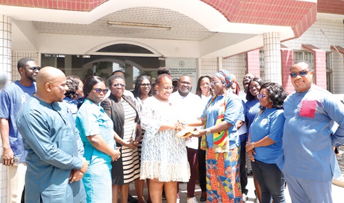 Alice Zu (3rd from right), Chief Procurement and Supply Chain Manager, Ministry of Information, making the presentation to Prof. Verna Vanderpuye (4th from left), Consultant Clinical Oncologist and Deputy Director National Radiotherapy Oncology and Nuclear Medicine Centre, KBTH,  as  other officials look on.  Picture: EDNA SALVO KOTEY