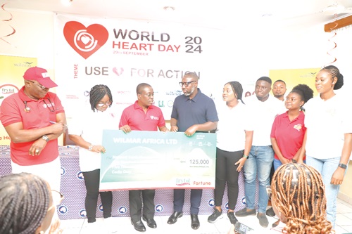 Solomon Ohene-Owusu (4th from left) of Wilmar Africa Limited, presenting a dummy cheque to Dr Kow Entsua-Mensah (3rd from left), Director, National Cardiothoracic Centre, at the launch, while other officials look on. Picture: EDNA SALVO KOTEY