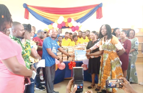 Prince Kwame Afetor (left), President of Rotary Club of Community 25, handing over the books to Frances Aboagye, Headmistress, Tema Manhean Community Primary School. Picture: BENJAMIN XORNAM GLOVER