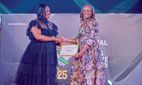Beatrice Afranie (right) receiving a certificate of honour from a representative of the organisers