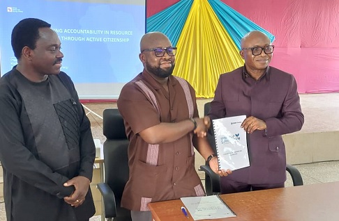 Kodzo Yaotse (2nd from left), Policy Lead, Petroleum and Conventional Energy at the ACEP, presenting the Campus Hub document to Professor Elvis Asare-Bediako (right), Vice Chancellor of the University of Energy and Natural Resources (UENR), after the launch