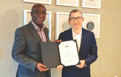  Prof. Kwame Akyeampong (left) with his letter of appointment, with Dr Charles CHEN Yidan, Founder of Yidan Prize Foundation