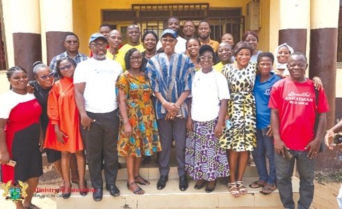 Dr Clement Apaak (middle), Deputy Education Minister, with the teachers after the visit