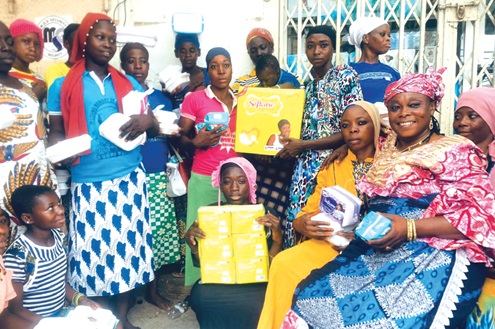Hajia Kwalebu Fuseinatu Sulemana (seated right), Event Organiser for Kunata Voluntary Organisation, with some of the beneficiary kayayei