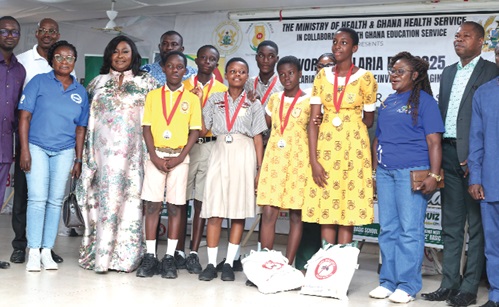 Gifty Anti (2nd from left), chairperson for the occasion, with Theresa Oppong Mensah (2nd from right), School Health Education Progamme Coordinator, contestants in the quiz  and sponsors of the programme after the competition. Picture: BENEDICT OBUOBI