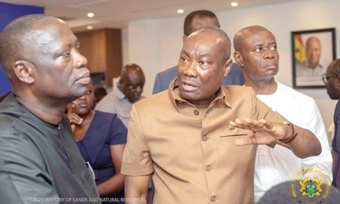 Martin Kwaku Ayisi (right), Chief Executive Officer, Minerals Commission, explaining a point to Emmanuel Armah-Kofi Buah, Minister of Lands and Natural Resources