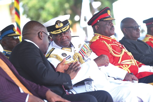 President John Dramani Mahama (2nd from left) interacting with Edward Omane Boamah (left), Minister of Defence, at the Regular Career Course 63 parade in Accra. Picture: SAMUEL TEI ADANO