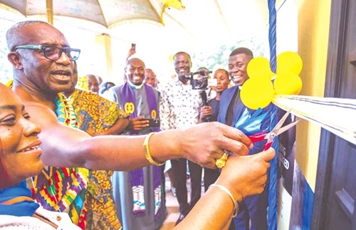 Osabarima Ansah Sasraku (2nd from left), Mamfehene, being assisted by Dina Opare (left), Headmistress of the Mamfe Methodist JHS, to inaugurate the ICT laboratory (inset). Looking on are officials of the Victor Yaw Asante Foundation and the Rotary Club of Ghana
