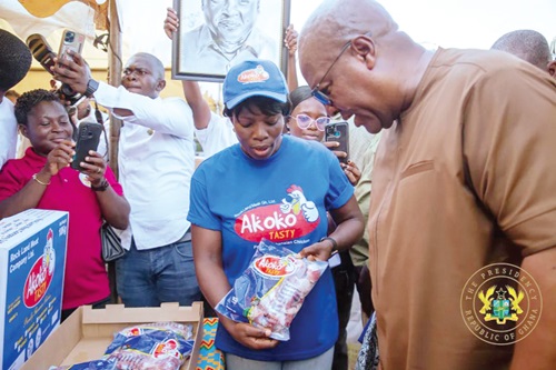 President John Mahama inspecting some products of a local meat processing company