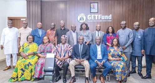 Haruna Iddrisu (seated 3rd from right), Minister  of Education, with members of the board
