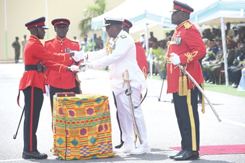President John Dramani Mahama (2nd from right) presenting the sword of honour to Senior Under Officer Mustapha Salim Danibja (left), Overall best Cadet, during the Regular Career Course 63. With them is Major General William Agyapong (right), Chief of the Defence Staff. Picture: SAMUEL TEI ADANO