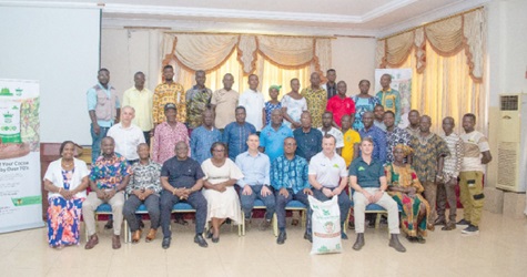 William Hunt (seated 3rd from right), Country Director of Demeter Ghana Limited, with his officials and the cocoa farmers