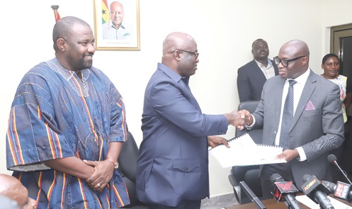 Eric Opoku (2nd from left), Minister of Food and Agriculture, exchanging signed documents with Alex Kwasi Awuah (right), Managing Director, ARP Apex Bank, at the ceremony. With them is John Dumelo (left), Deputy Minister of Food and Agriculture.  Picture: SAMUEL TEI ADANO 