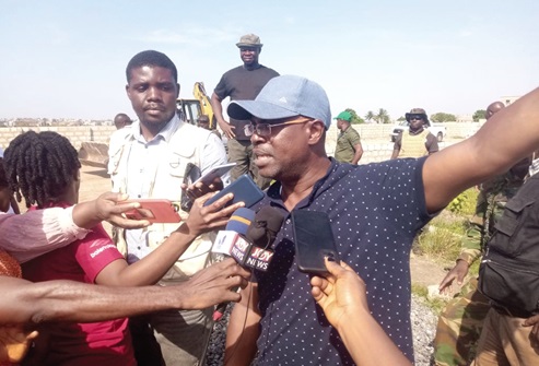 Some demolished structures. INSET: Courage Nunekpeku (inset), Managing Director of TDC Ghana Ltd, speaking to journalists